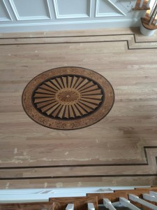 red oak floor installation with custom design