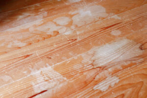 hardwood wood floors with water stains damage with white splotches from moisture and humidity that needs to be professional repaired and restored