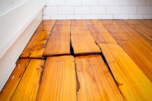 hardwood floor buckling warping cupping damage from winter moisture and weather for a professional like central mass hardwood to offer professional repair services