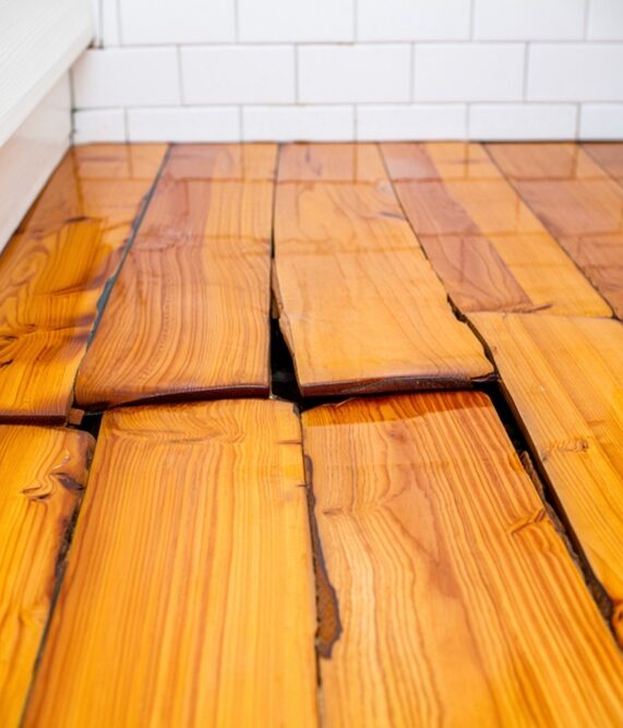 hardwood floor buckling warping cupping damage from winter moisture and weather for a professional like central mass hardwood to offer professional repair services