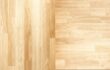 Side-by-side comparison of real hardwood flooring planks and luxury vinyl plank with similar wood-grain pattern.